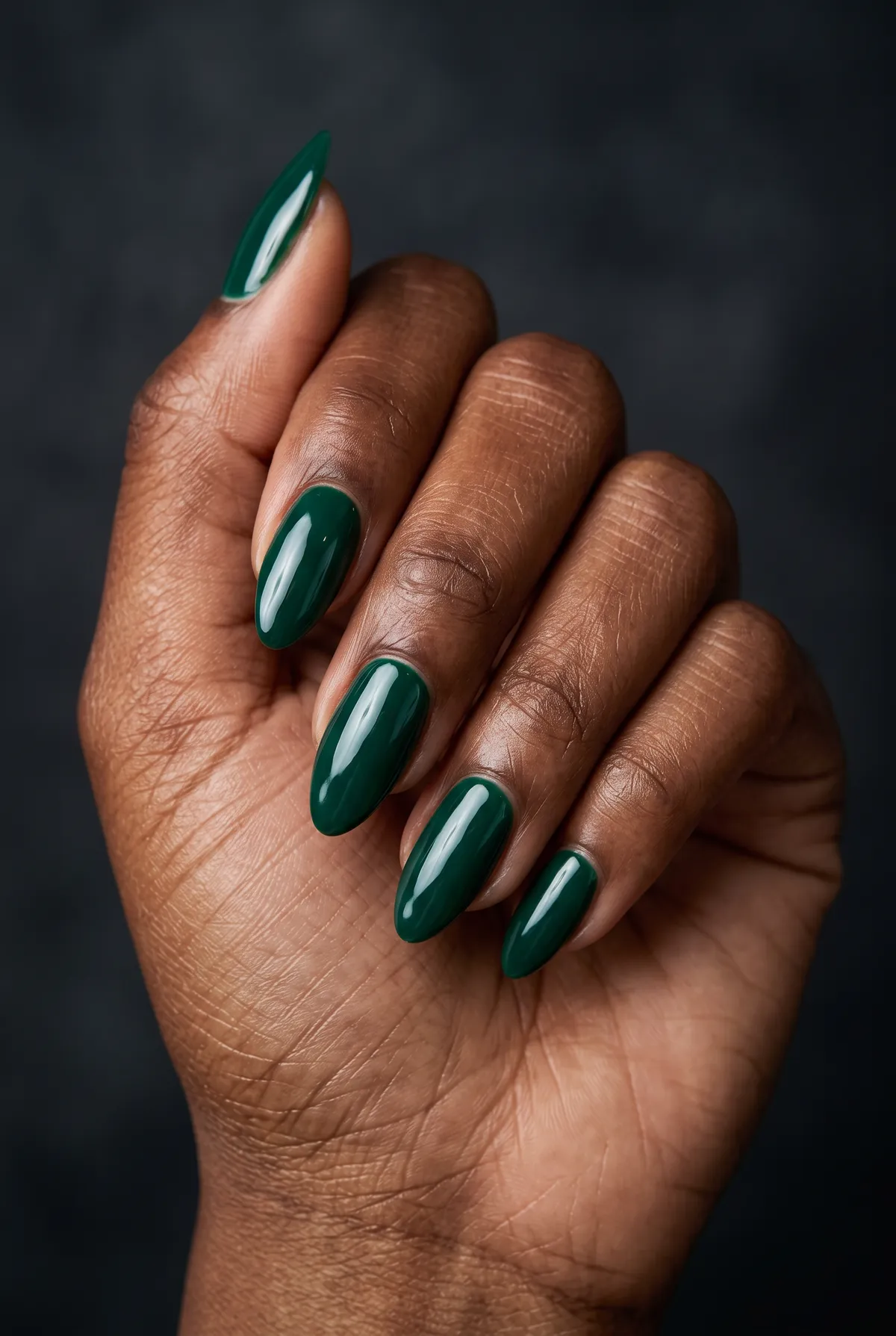 Emerald Glaze — almond christmas nails with please do a deep emerald green gel with a high-gloss glaze topcoat on almond-shaped nails