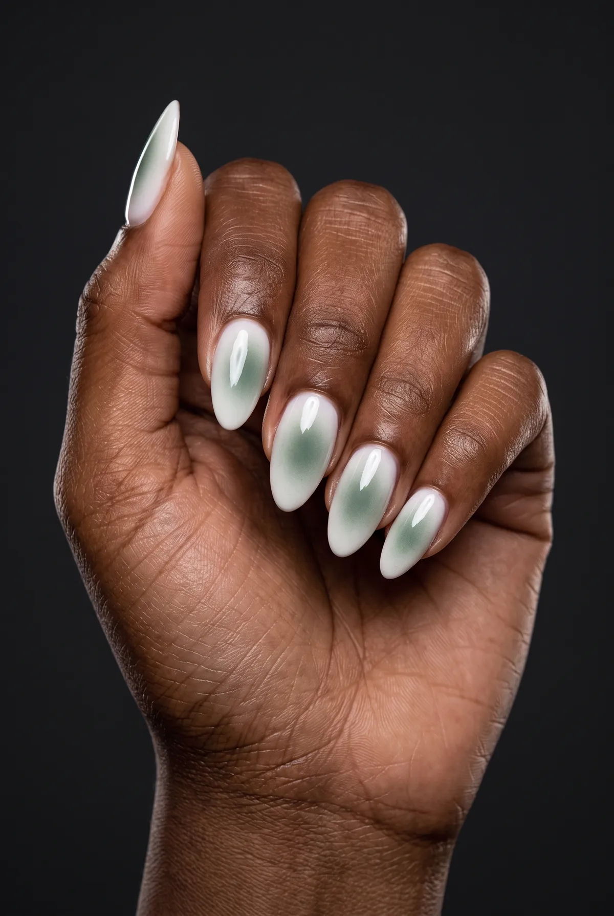 Frosted Pine Aura — almond christmas nails with blend a soft white base into a misty pine-green aura at the tips on almond nails