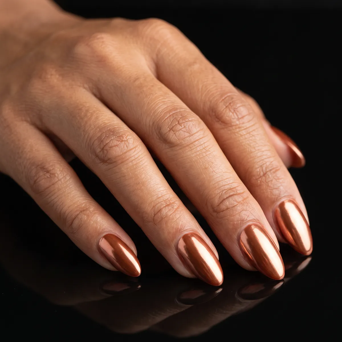 Copper Chrome — almond fall nails with copper chrome powder over a rust base, full mirror finish, medium almond