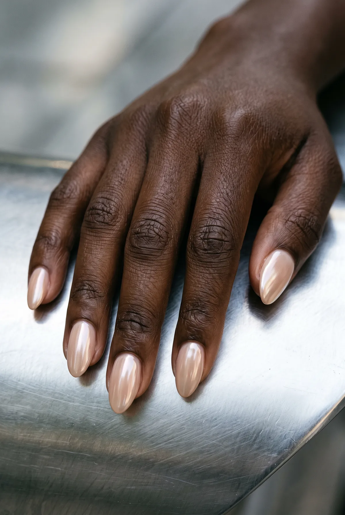Glazed & Unbothered — almond short almond nails with glazed-donut look: nude base with pearl chrome powder buffed over, short almond