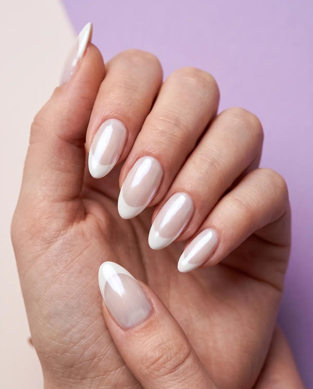 Glazed Pearl French — almond french nails with white french tips with a pearl chrome powder glazed over the full nail, almond, glass finish