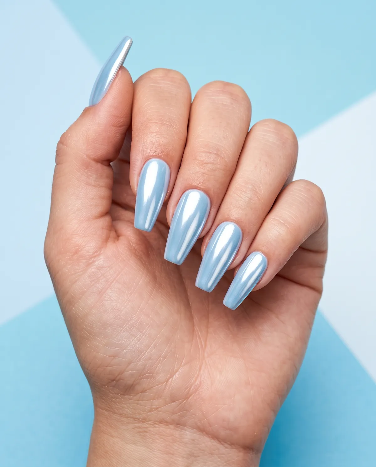 Glacier Chrome — coffin winter nails with coffin shape, long length, pale blue base, apply chrome powder for a mirror finish, seal with…